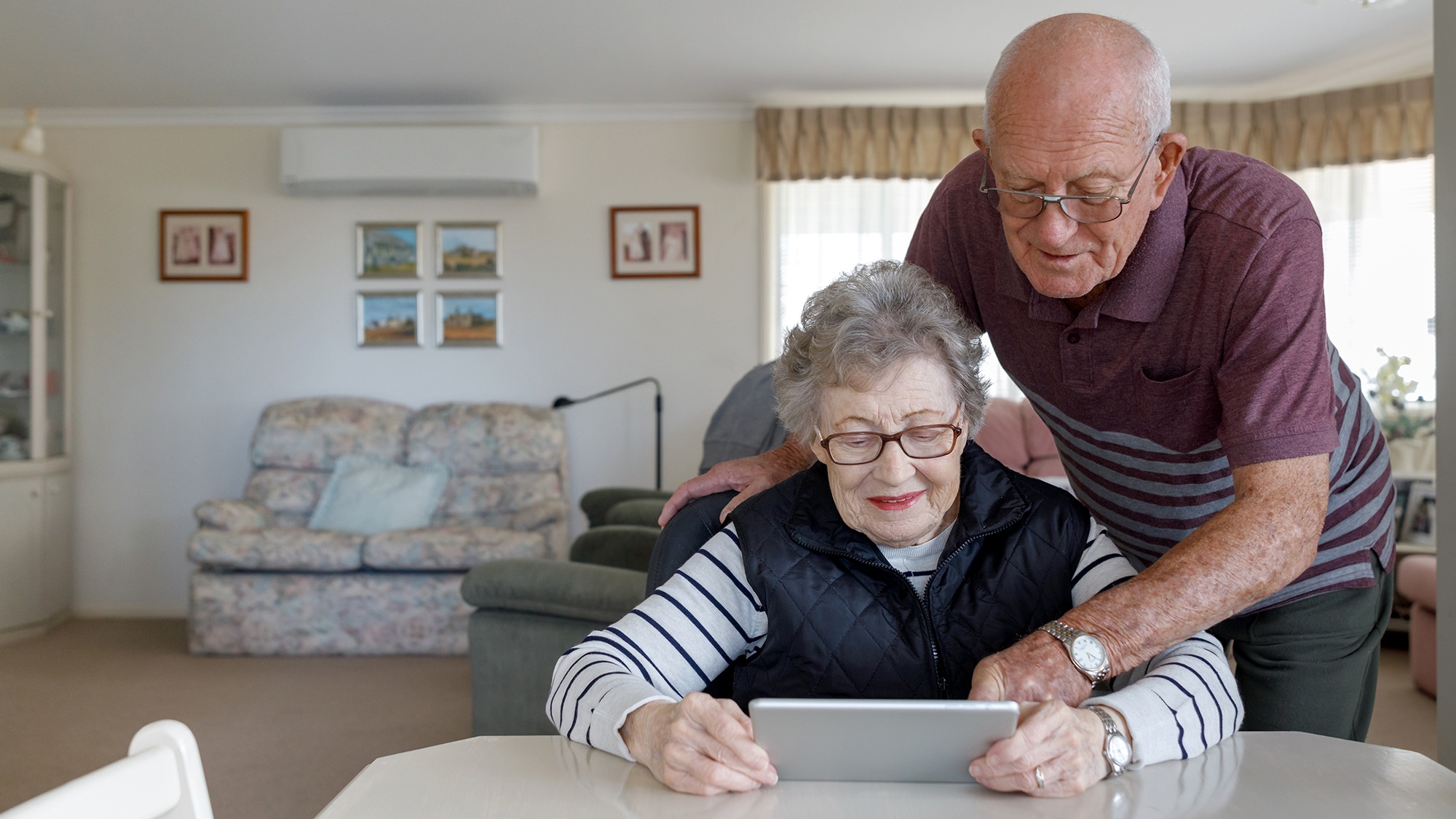 Senior Australian Couple Learning To Use Digital Tablet